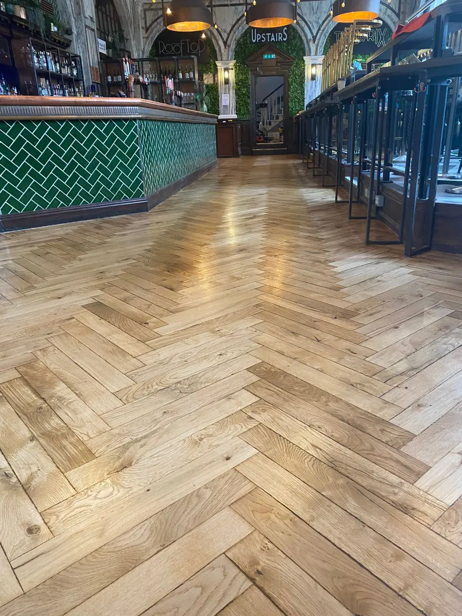 Sand and re-lacquer of existing herringbone parquet flooring at a Birmingham city centre bar School floor sanding